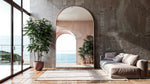 Aurora Blush Arch Mirror with brushed golden rose frame in modern living room reflecting ocean view