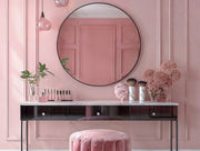 Noir Round Mirror with sleek black aluminum frame above black vanity in pink room