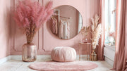 Eclipse round mirror with rose gold frame hanging in blush pink dressing room with pampas grass, round ottoman and window.