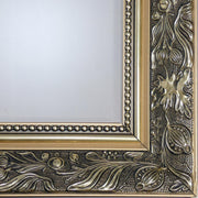 Close-up of Versailles Majesty Mirror ornate baroque gold frame with intricate floral and scroll detailing